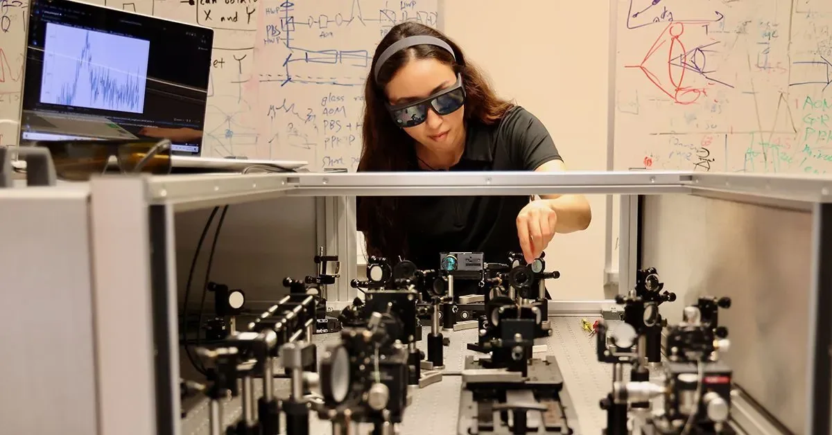 MRSEC researcher aligning an ultrafast laser on an optical table at UC San Diego