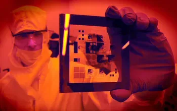 Cleanroom researcher inspecting a patterned wafer at the San Diego Nanotechnology Infrastructure